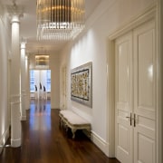 View of the entrance way featuring mahogany floors, ceiling, floor, flooring, hall, hardwood, home, interior design, molding, room, wall, window, wood, wood flooring, brown, gray