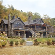 View of the holiday homes exterior featuring white cottage, estate, farmhouse, historic house, home, house, landscape, property, real estate, residential area, roof, siding, tree, brown