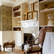 View of seating in the master bedroom featuring bookcase, cabinetry, ceiling, chair, floor, flooring, furniture, hardwood, home, interior design, living room, room, shelf, shelving, wall, gray, brown
