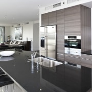 View of the open plan living area featuring countertop, interior design, kitchen, white, black, gray