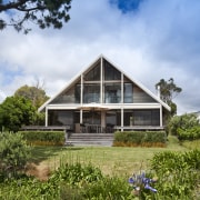 View of renovated beach house designed by architect cottage, estate, facade, farmhouse, grass, home, house, landscape, plant, plantation, property, real estate, residential area, sky, tree, villa, brown