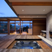 View of spa area with outdoor fireplace and architecture, estate, home, house, interior design, lighting, living room, real estate, swimming pool, window, wood, brown