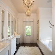 View of the master bathroom which features a ceiling, estate, floor, flooring, home, interior design, molding, room, wall, window, gray, orange