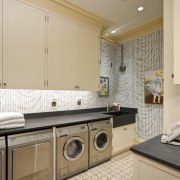 Interior view of this laundry area which features countertop, home, interior design, kitchen, laundry, laundry room, property, real estate, room, orange