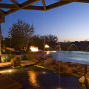 View of a grand Las Vegas Home that architecture, evening, home, landscape lighting, lighting, night, real estate, reflection, sky, swimming pool, water, wood, brown