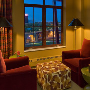 View of seating in the bedroom with standing home, interior design, lighting, living room, room, suite, window, red, brown