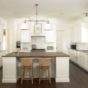 The kitchen is in a traditional, clean style, cabinetry, ceiling, countertop, cuisine classique, floor, flooring, hardwood, interior design, kitchen, laminate flooring, room, wood flooring, white