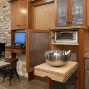 View of this contemporary kitchen with many accessories cabinetry, countertop, flooring, furniture, home, interior design, kitchen, room, table, wood, wood stain, brown, orange