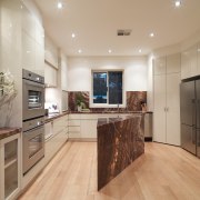 Interior view of this modern kitchen - Interior cabinetry, countertop, floor, flooring, hardwood, interior design, kitchen, laminate flooring, property, real estate, room, wood flooring, orange, gray, brown