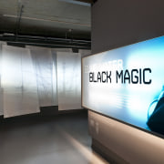 Translucent coloured polycarbonate panels define the angled facade display device, technology, tourist attraction, black