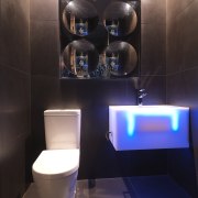 View of a themed bathroom with feature wall bathroom, interior design, lighting, plumbing fixture, product design, purple, room, toilet, black