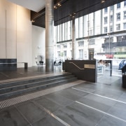 Interior view of the Deloitte Centre offices which architecture, daylighting, floor, flooring, interior design, lobby, tile, wood, gray, black