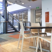 View of the staff room of the BNZ architecture, chair, floor, flooring, furniture, interior design, table, wood, gray, orange