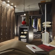 View of the walk-in closet which features a furniture, interior design, room, black, brown