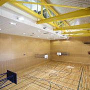 Interior view of the gymnasium of the St architecture, ceiling, daylighting, floor, flooring, interior design, leisure centre, line, sport venue, structure, wall, wood, yellow, orange