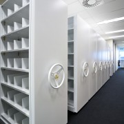 View of adjustable storage shelves with lockable handwheels. product, product design, shelving, white, gray