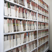 View of adjustable storage shelves with lockable handwheels. bookcase, institution, library, library science, public library, shelf, shelving, gray