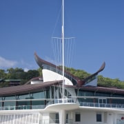 Copper roofing was specified for the yacht club boat, boating, sailboat, sea, sky, water, watercraft, yacht, blue, teal