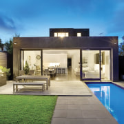 Exterior view of a flat-roofed home designed and architecture, backyard, elevation, estate, facade, family car, home, house, interior design, lighting, property, real estate, residential area, swimming pool, villa, yard, teal