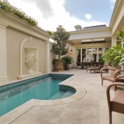 View of this pool and patio features outdoor apartment, estate, hacienda, home, house, leisure, property, real estate, resort, swimming pool, villa, gray, brown