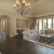 Living room features furniture, chandelier &amp; windows ceiling, estate, floor, flooring, hardwood, home, interior design, living room, property, real estate, room, wall, window, wood flooring, brown