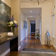 View of hallway of this house built by ceiling, estate, floor, flooring, hall, hardwood, home, interior design, laminate flooring, lighting, living room, lobby, molding, real estate, room, wall, wood flooring, brown, orange