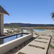 View of the outdoor area and pool of arecales, estate, home, house, leisure, palm tree, property, real estate, resort, swimming pool, villa, teal, gray