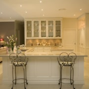 View of large, open-plan kitchen featuring overhead cabinetry cabinetry, ceiling, countertop, cuisine classique, dining room, flooring, home, interior design, kitchen, room, under cabinet lighting, orange, brown