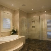View of master bathroom which features dark coloured bathroom, ceiling, estate, floor, home, interior design, property, real estate, room, window, brown, orange