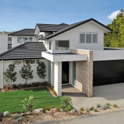 Exterior view of Jalcon Homes show home which cottage, elevation, facade, home, house, property, real estate, residential area, roof, siding, gray