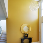 View of the entranceway to this contemporary home architecture, ceiling, daylighting, home, house, interior design, light fixture, lighting, paint, product design, room, table, wall, yellow, orange