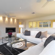 View of lounge which features L-shaped white sofa, ceiling, floor, home, interior design, living room, property, real estate, room, gray