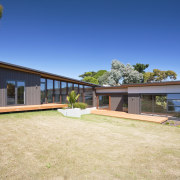 Exterior view of a home which is part cottage, estate, facade, farmhouse, home, house, landscape, property, real estate, villa, yard, orange, blue