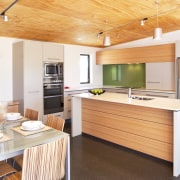 view of kitchen which features island, white benchtops, architecture, cabinetry, countertop, interior design, kitchen, real estate, wood, white, orange