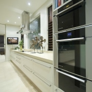 View of the kitchen area which features an cabinetry, countertop, interior design, kitchen, gray