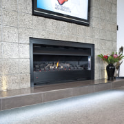 View of a living area which features woolen fireplace, hearth, gray