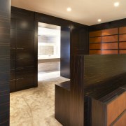 View of the bedroom which features wooden panelling architecture, cabinetry, floor, flooring, hardwood, interior design, laminate flooring, lobby, tile, wall, wood, wood flooring, wood stain, brown, orange