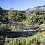 View of surrounding landscape of a energy-efficient development. biome, botanical garden, lake, landscape, mountain, nature, nature reserve, plant, pond, reflection, reservoir, riparian zone, tree, vegetation, water, water resources, watercourse, wilderness