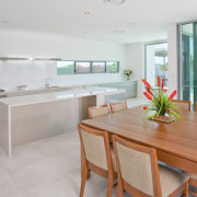 View of a kitchen and dining area which architecture, countertop, floor, house, interior design, kitchen, property, real estate, room, gray