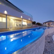 Exterior view of a holiday home designed by apartment, estate, home, hotel, house, leisure, leisure centre, property, real estate, resort, resort town, sky, swimming pool, villa, blue