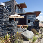 Exterior view of home which features angled and architecture, building, cottage, elevation, facade, home, house, property, real estate, residential area, siding, teal