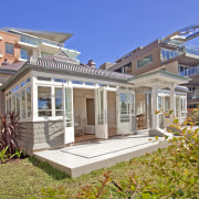 View of beachfront house with courtyard, formal living cottage, elevation, estate, facade, home, house, mixed use, property, real estate, residential area, villa, gray