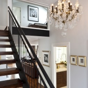 Close up view of the stairway and chandelier baluster, ceiling, dining room, estate, floor, flooring, handrail, hardwood, home, house, interior design, light fixture, lighting, molding, room, stairs, wall, wood, wood flooring, gray