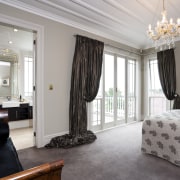 The bedroom of this traditonal home - The bedroom, ceiling, curtain, floor, home, interior design, living room, property, real estate, room, suite, wall, window, window covering, window treatment, gray