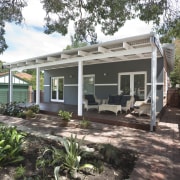 Exterior view of this patio - Exterior view backyard, cottage, home, house, outdoor structure, property, real estate, siding, tree, black, white