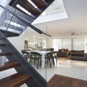 Modern stairway situated by dining &amp; living area apartment, architecture, ceiling, daylighting, floor, handrail, house, interior design, penthouse apartment, real estate, gray, black