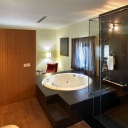 View of contemporary bedroom with wooden flooring and architecture, bathroom, ceiling, floor, flooring, interior design, real estate, room, sink, suite, brown