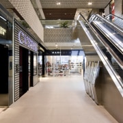 The escalators leading up to next level - floor, flooring, metropolitan area, retail, shopping mall, gray