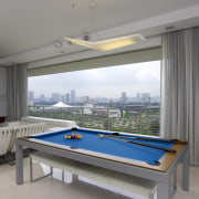 View of the pool table in this living billiard room, billiard table, cue sports, furniture, indoor games and sports, interior design, pool, real estate, recreation room, table, gray