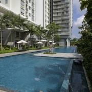 The pool which has water feature and surrounding apartment, arecales, building, condominium, estate, hotel, leisure, palm tree, property, real estate, resort, swimming pool, water, teal, gray